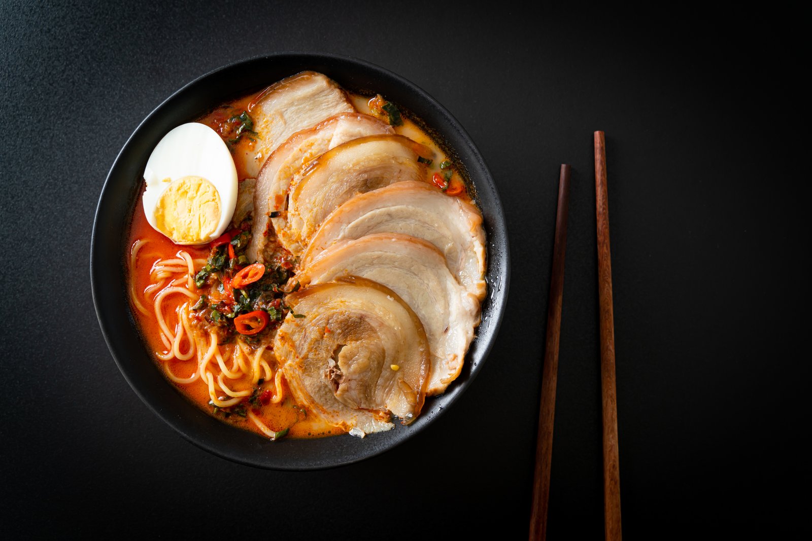 Kara Chashu Ramen — fiery tonkotsu base with house chili oil, thick-cut chashu, and soft egg